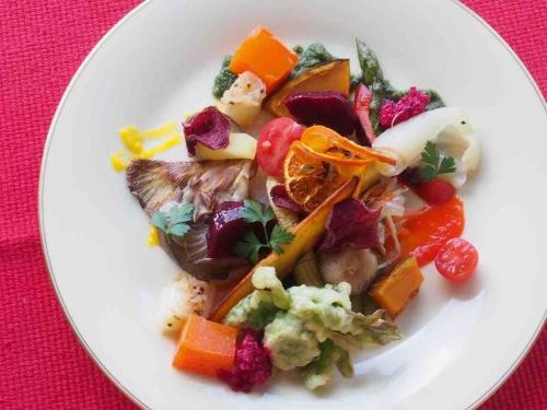 a white plate of food with vegetables on a table at Azumino Salon in Azumino