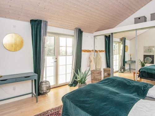a bedroom with a bed and a large window at Holiday home Silkeborg XXII in Silkeborg
