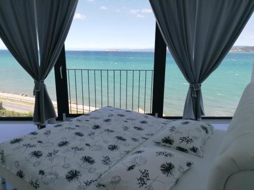 a bedroom with a bed and a view of the ocean at VILA MOLET KOPER in Koper