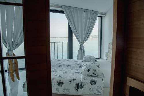 a bedroom with a bed and a large window at VILA MOLET KOPER in Koper