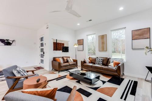 a living room with couches and a table at Modern Luxury In The City at Havilah Estates in Atlanta