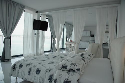 a bedroom with a bed with a white bedspread at VILA MOLET KOPER in Koper