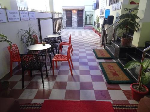 a restaurant with a checkered floor and tables and chairs at Foreigners Inn in Varanasi