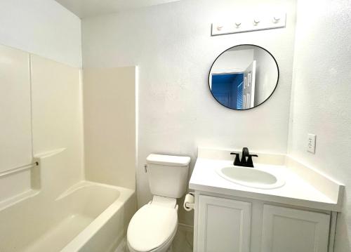 a white bathroom with a sink and a mirror at House vacation near downtown Dallas in Dallas