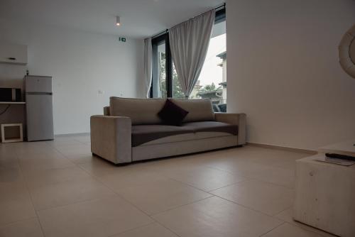 a living room with a couch and a large window at VILA MOLET KOPER in Koper