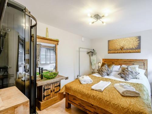 a bedroom with a bed and a glass shower at Orchard Retreat in Kirton