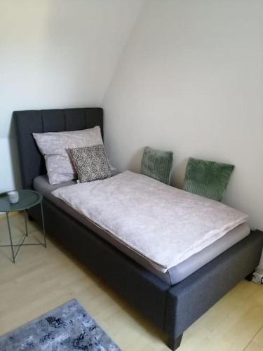 a bed with two chairs and a table in a room at Appartement bei Schloß Ulmerfeld in Ulmerfeld