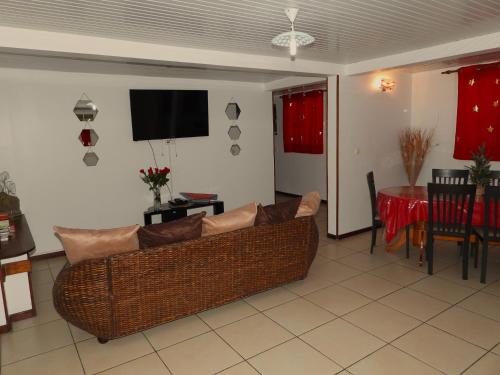 ein Wohnzimmer mit einem Sofa und einem Tisch in der Unterkunft bas de VILLA LARCHER avec piscine in Le Marin