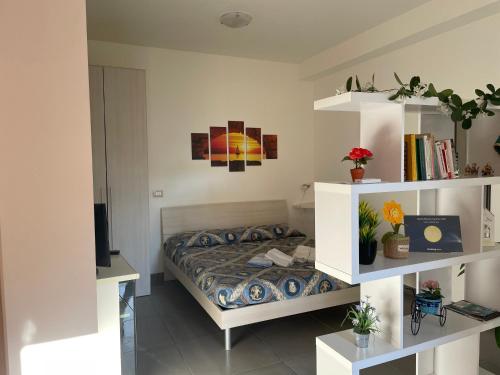 a bedroom with a bed and a book shelf at Villa Gelsomino in Avola
