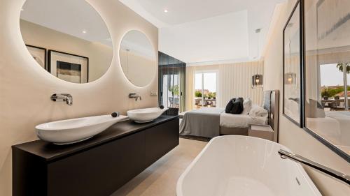 a bathroom with two sinks and a large mirror at Luxury apartment at Monte Paraiso in Marbella