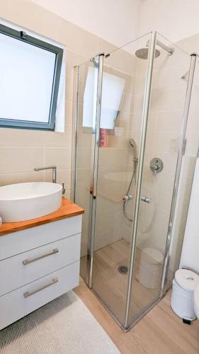 a bathroom with a shower and a sink at Charming unit in Dead Sea in Ovnat