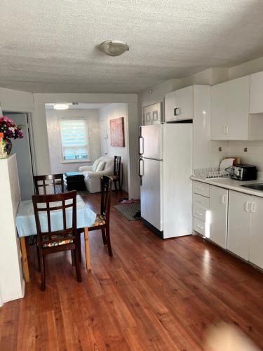 a kitchen with a white refrigerator and a table and chairs at appartement avec 2 chambres in Quebec City