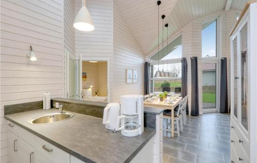 a kitchen with a sink and a counter with a table at Amazing Home In Krems Iiwarderbrück in Göls