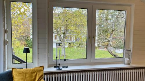 a window sill with three windows in a room at Quiet 2 room garden loft with terrace in Bad Tölz