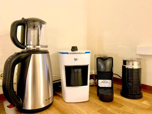 a blender and a coffee maker sitting on a table at MINIQ HOMES 102 - Historical Stone House with Garden Cinema in Foca