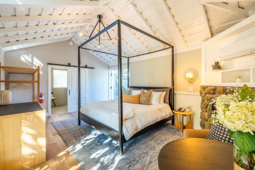 a bedroom with a canopy bed in a room at The Ruse in Healdsburg