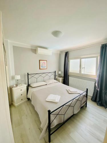 a bedroom with a large bed and a window at LHV Garda Lake - Private POOL and SPA in Bardolino