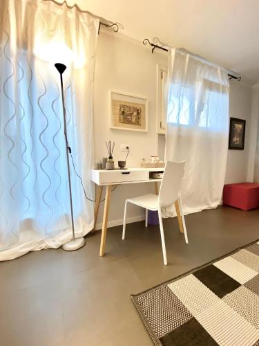a room with a desk and a table and a lamp at LHV Garda Lake - Private POOL and SPA in Bardolino