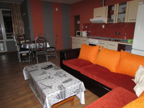 a living room with two couches and a table at Morska Zvezda Guest house in Pomorie