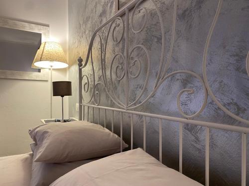 a bedroom with two beds and a wall at LHV Garda Lake - Private POOL and SPA in Bardolino