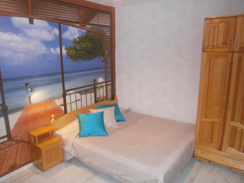 a bedroom with a bed with a view of the ocean at Morska Zvezda Guest house in Pomorie