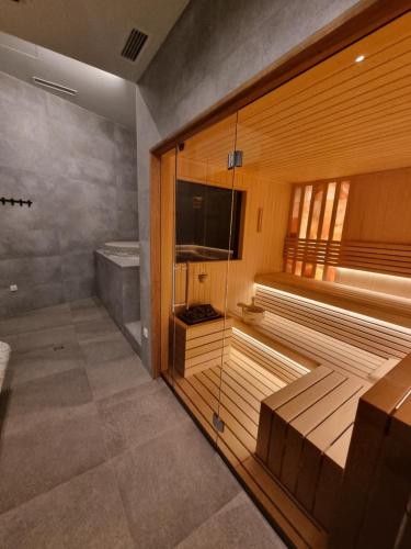 a sauna with a flat screen tv in a room at Apartman Drvorez-direktno na ski stazi in Jahorina