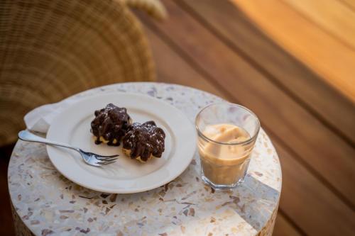 a plate of food on a table with a drink at Thornybush Game Lodge in Thornybush Game Reserve