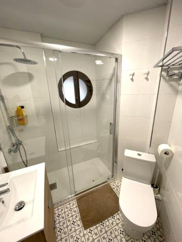 a bathroom with a shower and a toilet and a sink at Plaza de España independent house in Barcelona
