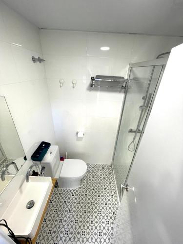 a bathroom with a shower and a toilet and a sink at Plaza de España independent house in Barcelona