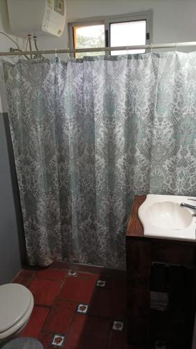 baño con lavabo y cortina de ducha en Apartamento Las Hortensias, en La Pedrera