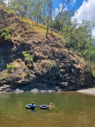 two people in the water in a river at Amaroo Escape in Coneac