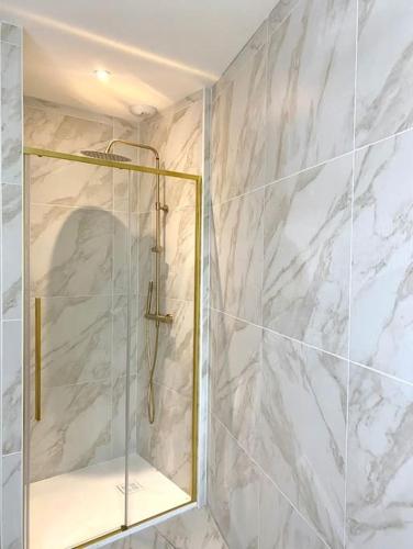 a bathroom with a shower with a mirror at Villa Contemporaine in Châtellerault