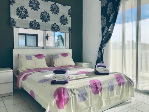a bedroom with a bed with two hello kitty towels on it at Diana Townhouse 5 in Paphos