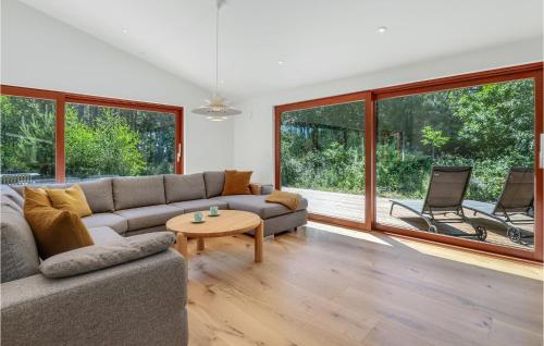 a living room with a couch and a table at Nice Home In Nexø With Sauna in Neksø