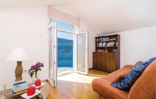 a living room with a couch and an open door at Apartment Baosici Baosici in Herceg-Novi