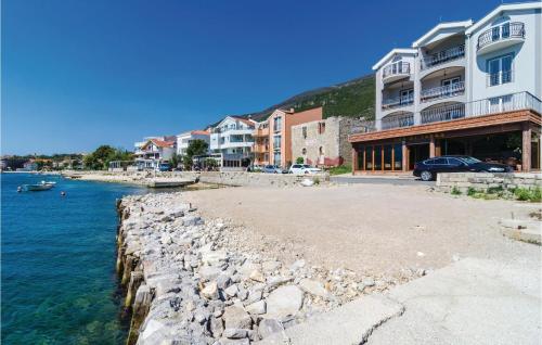 a group of buildings next to a body of water at Apartment Baosici Baosici in Herceg-Novi