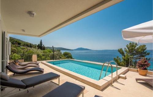 a villa with a swimming pool and a view of the ocean at Amazing Home In Martinscica in Martinšćica