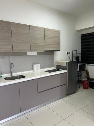 a kitchen with white counters and stainless steel appliances at Cozy Private Studio Apartment with View in Shah Alam