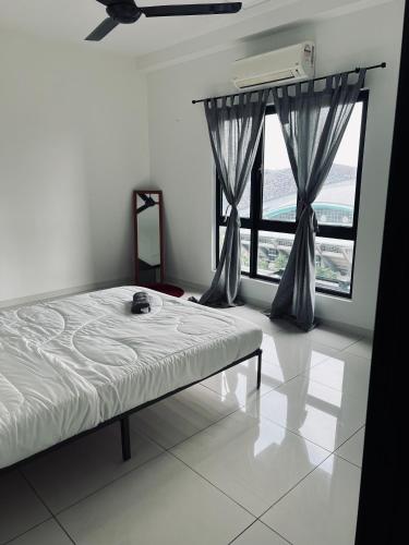 a bedroom with a bed and a large window at Cozy Private Studio Apartment with View in Shah Alam