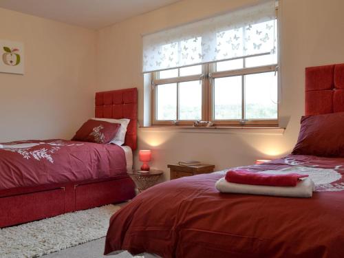 a bedroom with two beds and a window at Beith in Kilmuir