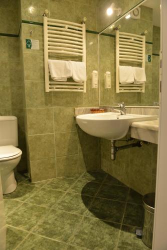 a bathroom with a sink and a toilet at Hotel Bellevue in Skopje