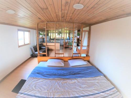a bedroom with a large bed with a wooden ceiling at Room Papagayo - Ayampe in Ayampe