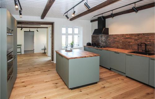 a large kitchen with a counter top in a room at Stunning Home In Samsø With Wifi in Ballen