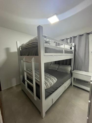 a couple of bunk beds in a room at Beautiful Condo in La Romana with pool near Caleta Beach in La Romana