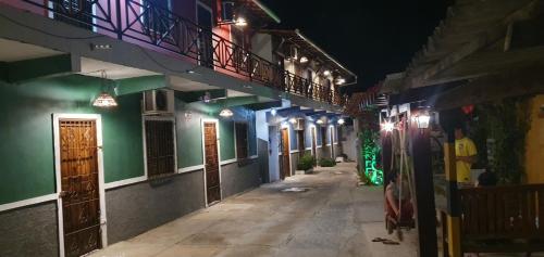 an empty alley at night with lights on the buildings at Flatstom in Parnaíba