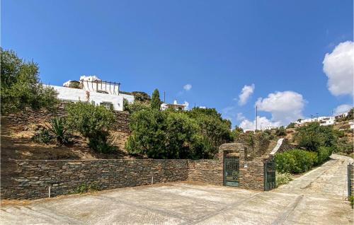 a stone wall with a gate on a hill at Lovely Home In Sifnos With Wifi in Sifnos