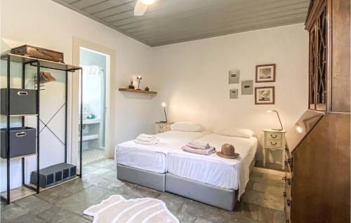 a bedroom with a white bed and a mirror at Lovely Home In Sifnos With Wifi in Sifnos