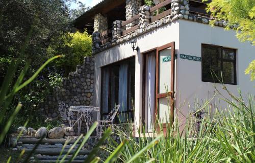 a small house with a table and chairs in front of it at Wildebraam Berry Estate in Swellendam