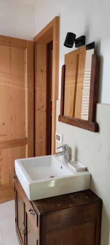 a bathroom with a white sink and a mirror at Casa Zefìra in Feltre