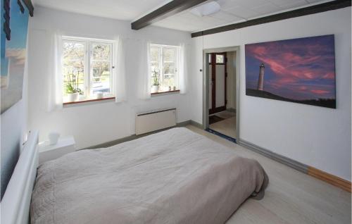 a white bedroom with a large bed and windows at Awesome Home In Sams With Wifi in Ballen